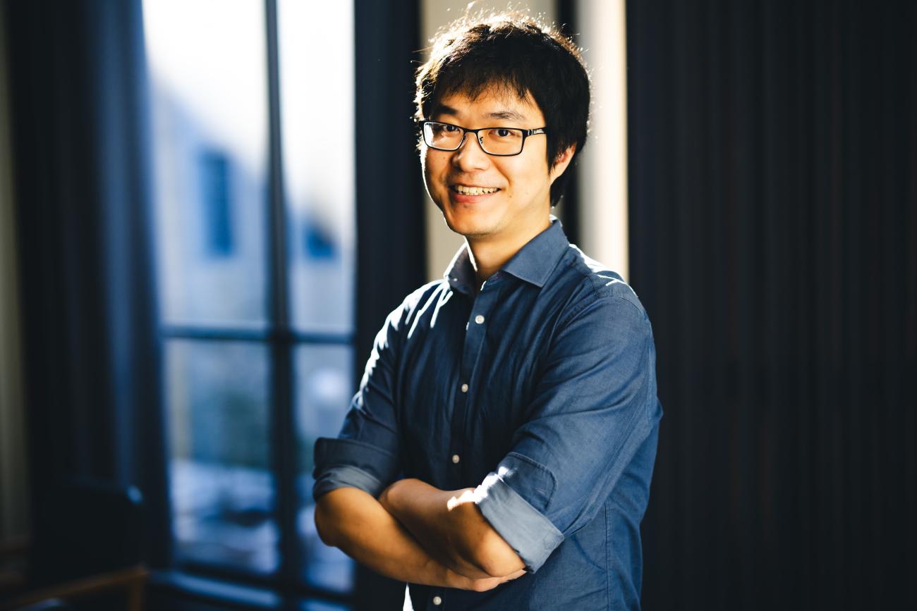 Chenshu Liu stands for a portrait smiling at the camera